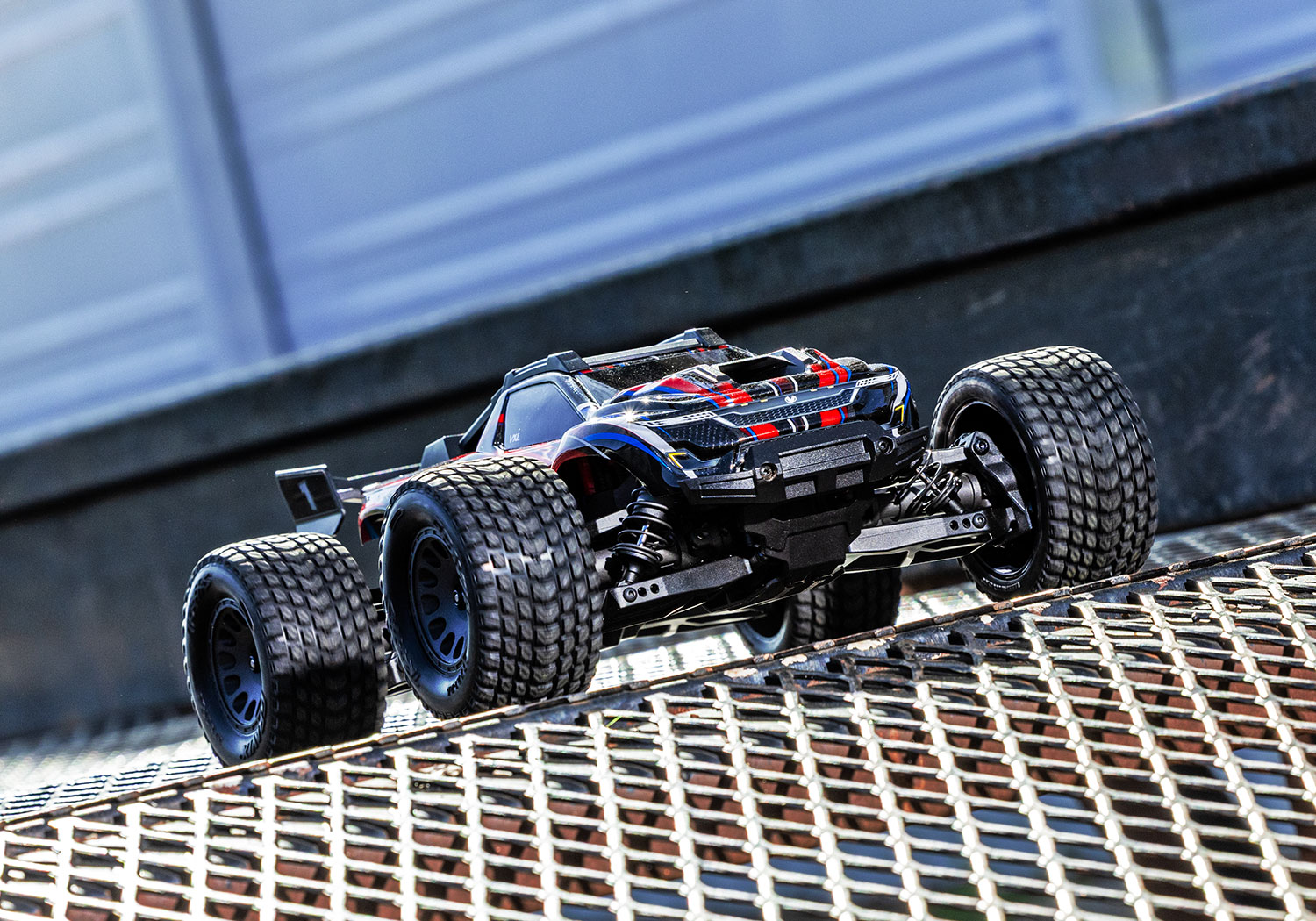 An action shot of the Mini XRT Ready to Run with Battery and Charger (Blue) (TRA108076-1-BLUE).