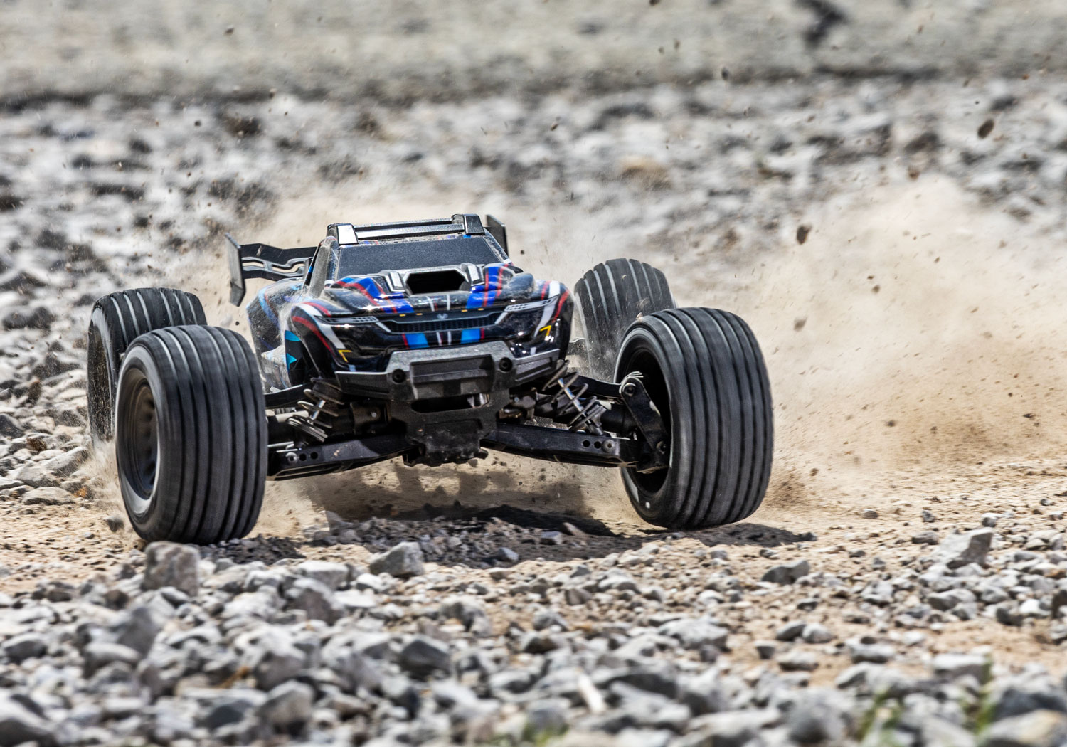 An action shot of the Mini XRT Ready to Run with Battery and Charger (Blue) (TRA108076-1-BLUE).