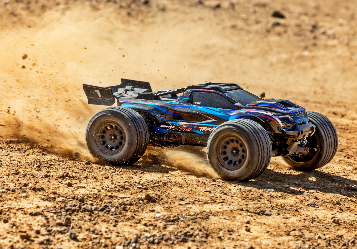 An action shot of the Mini XRT Ready to Run with Battery and Charger (Blue) (TRA108076-1-BLUE).