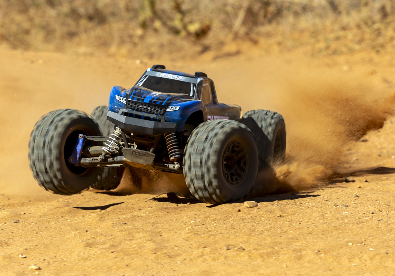 An action shot of the 1/10 Stampede 4x4 BL-2S Ready to Run (Blue) (TRA67154-4-BLUE).