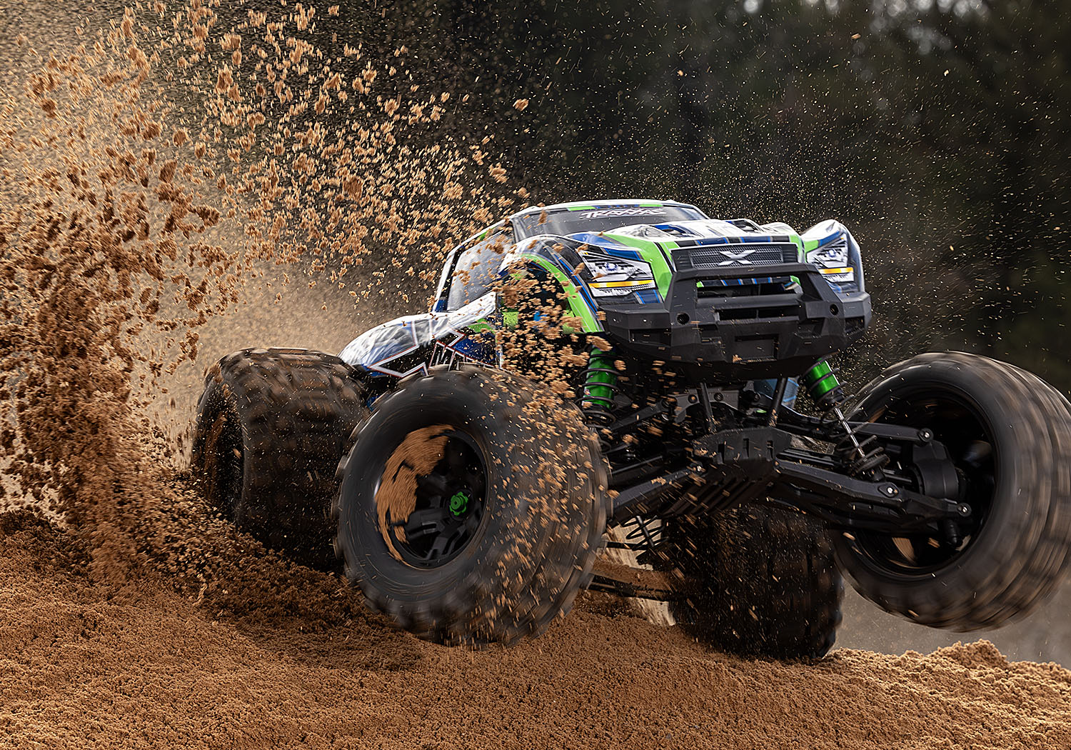 An action shot of the X-Maxx 8S with Belted Sledgehammer Tires (Blue) (TRA77096-4-BLUE).
