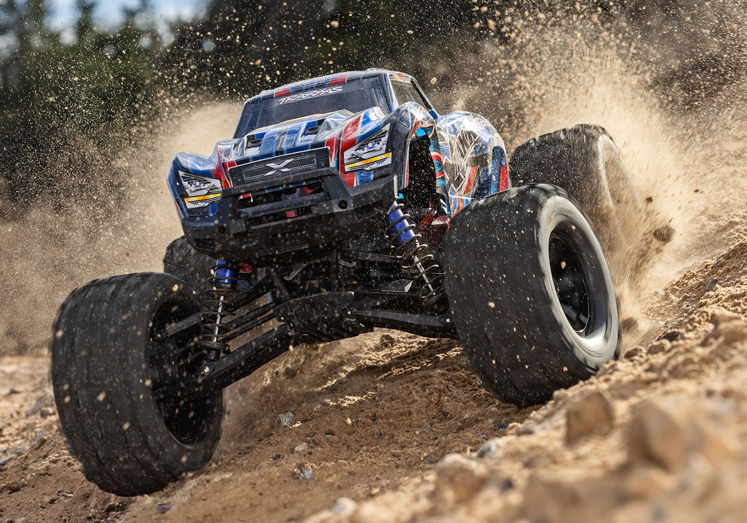 An action shot of the X-Maxx 8S with Belted Sledgehammer Tires (Blue) (TRA77096-4-BLUE).