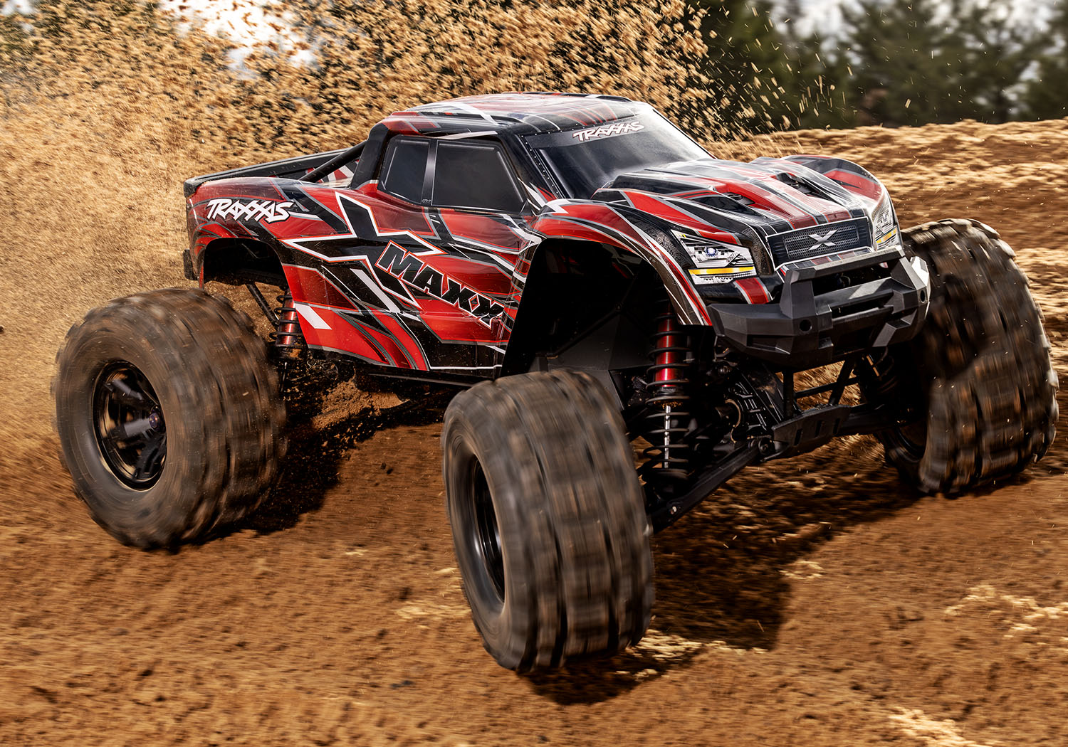 An action shot of the X-Maxx 8S with Belted Sledgehammer Tires (Blue) (TRA77096-4-BLUE).