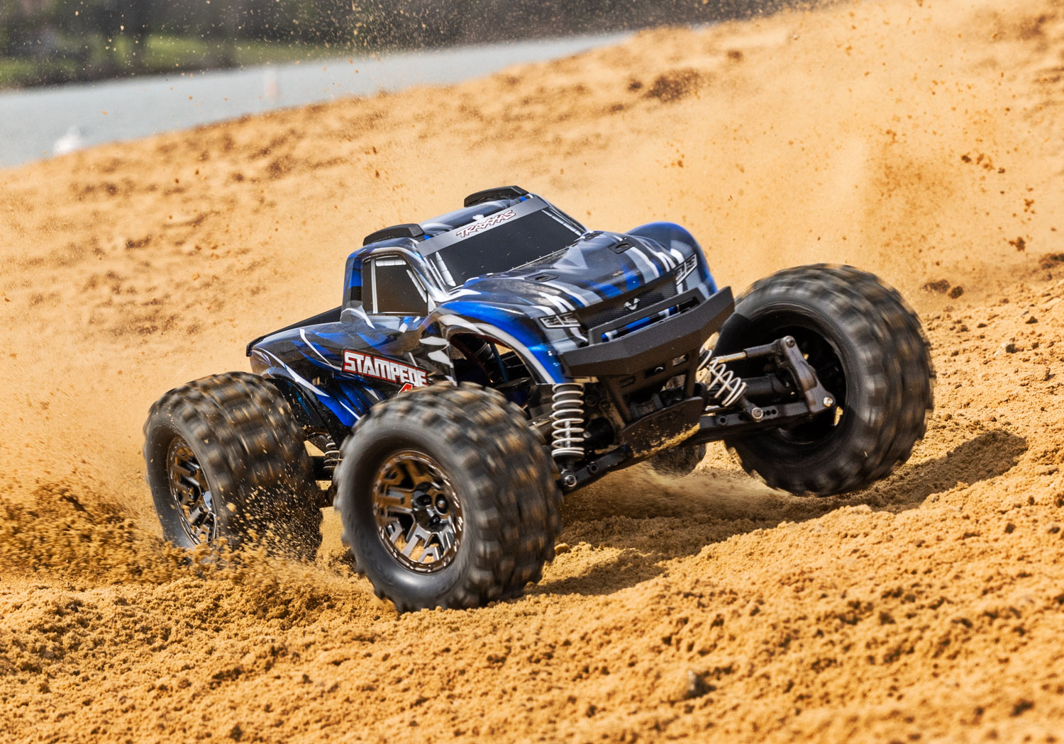 An action shot of the 1/10 Stampede 4x4 VXL with 540XL Motor Ready to Run (Orange) (TRA90376-4-ORNG).