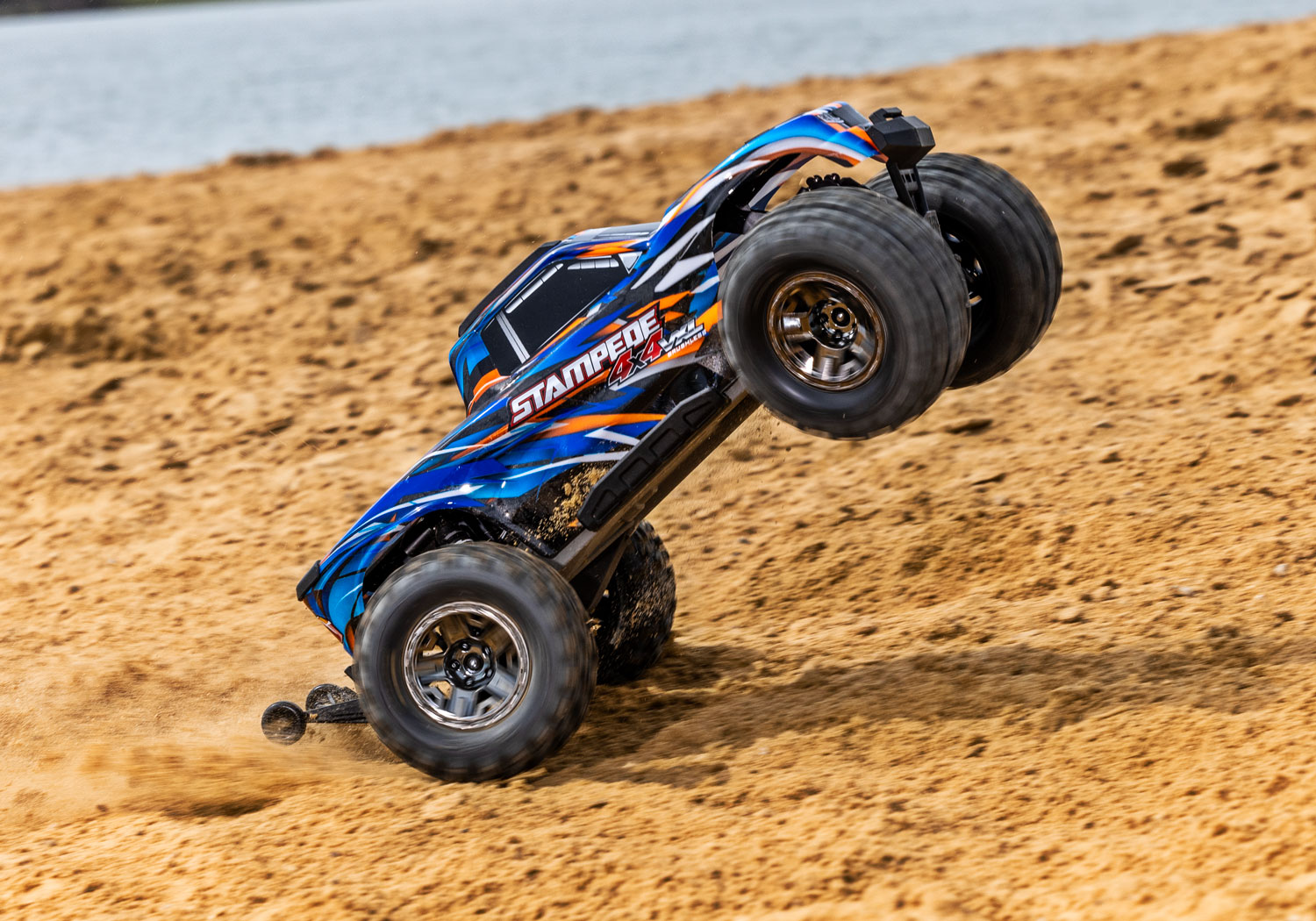 An action shot of the 1/10 Stampede 4x4 VXL with 540XL Motor Ready to Run (Orange) (TRA90376-4-ORNG).