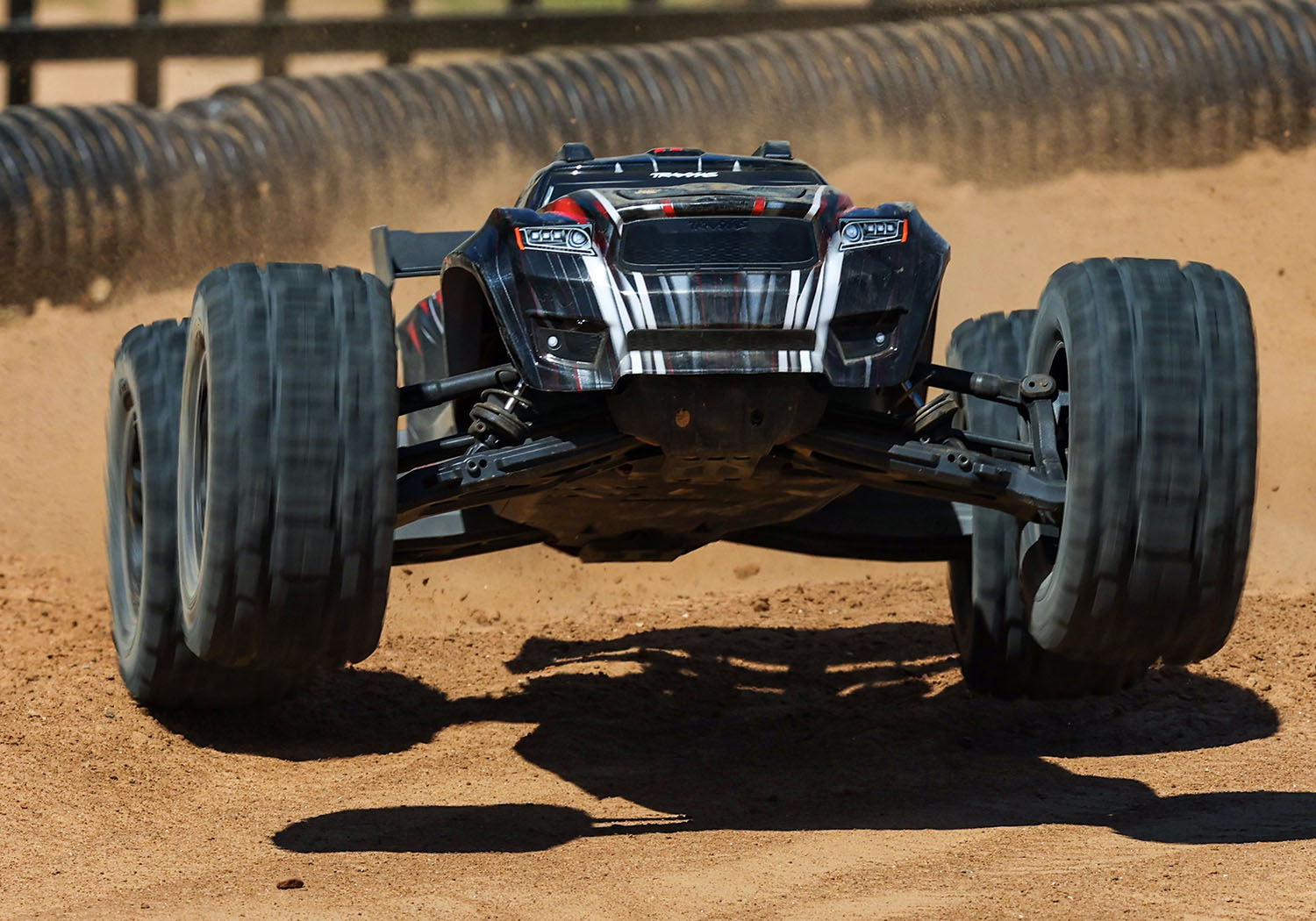 An action shot of the 1/8 Sledge with Belted Sledgehammer Tires Ready to Run (Blue) (TRA95096-4-BLUE).