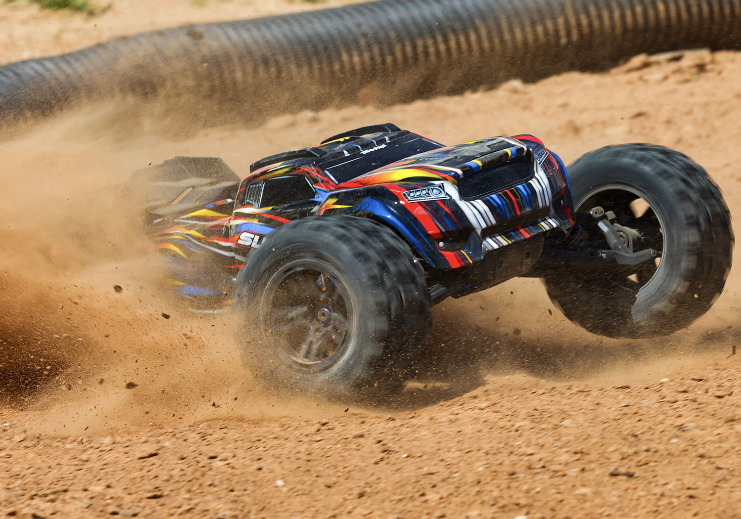 An action shot of the 1/8 Sledge with Belted Sledgehammer Tires Ready to Run (Blue) (TRA95096-4-BLUE).