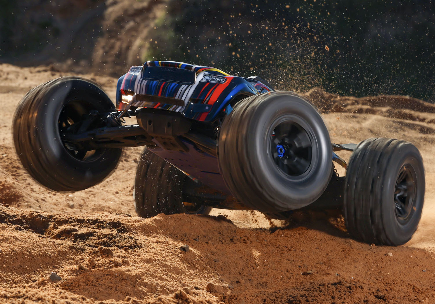 An action shot of the 1/8 Sledge with Belted Sledgehammer Tires Ready to Run (Blue) (TRA95096-4-BLUE).